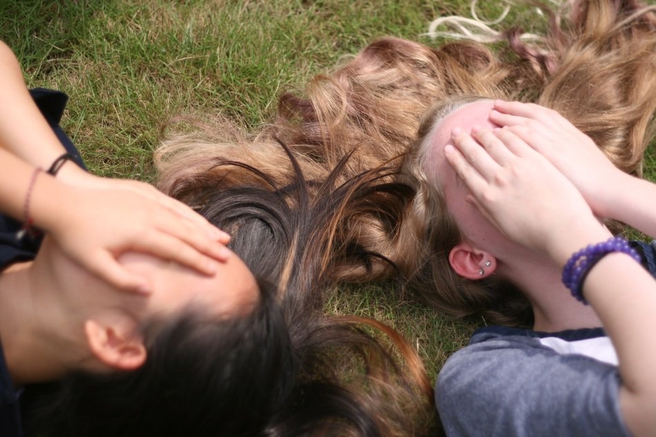 girls with long hair on the grass