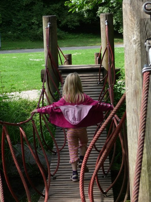 girl on the wooden bridge in the park