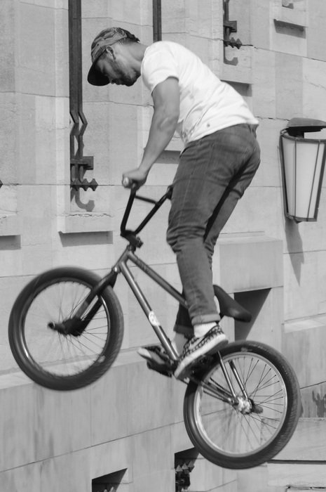 Black and white image of a cyclist in a jump