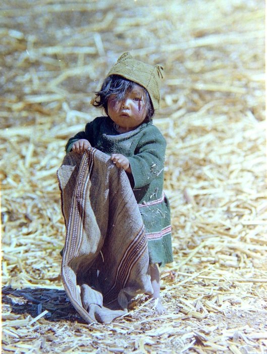poor peruvian child on the field