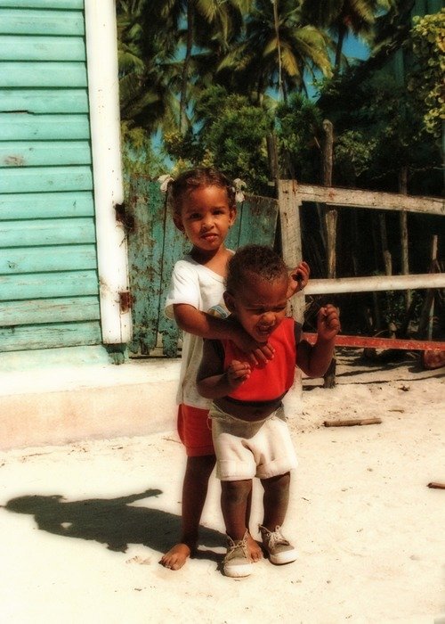 poor dark-skinned children on the beach in the Dominican Republic