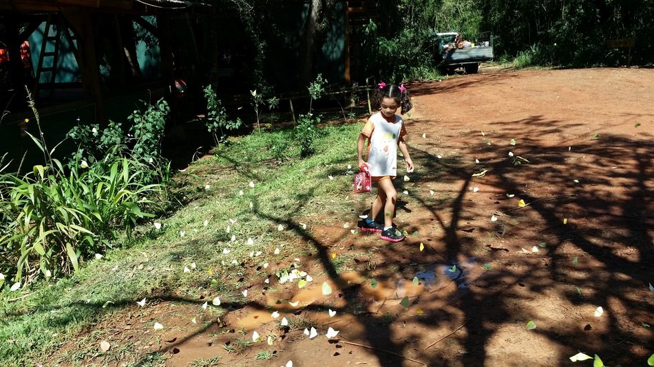 girl runs along the road near the trees