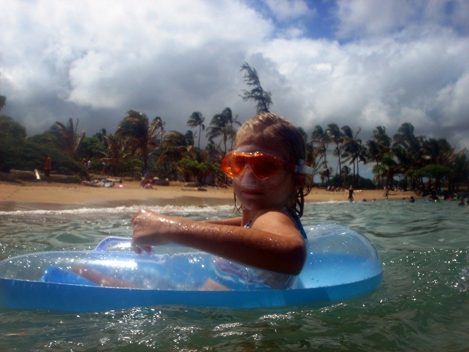 girl in a swimming mask and a rubber ring in the sea