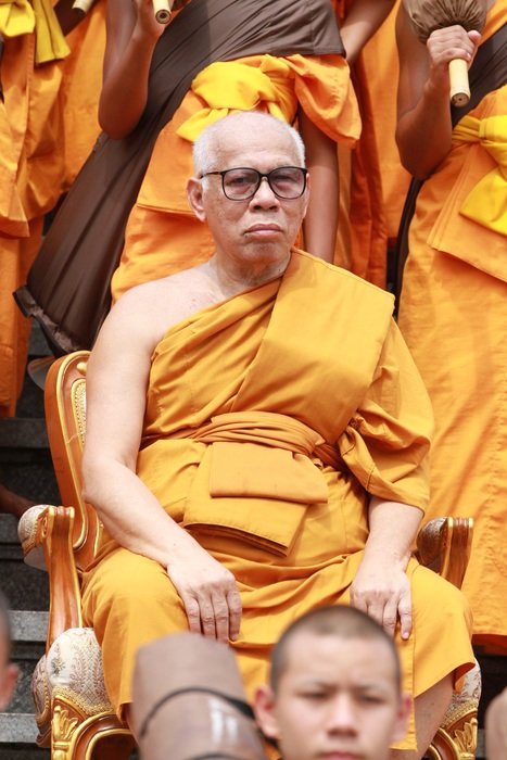Buddhists in orange robes at the ceremony