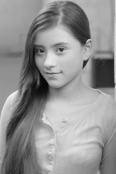 Black and white portrait photo of the young teen girl