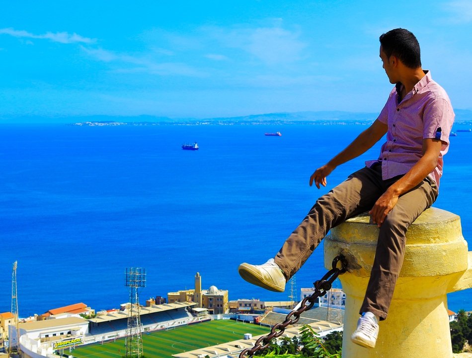 Young man looking at blue ocean