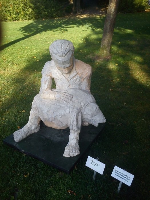 sculpture of a man with fish in the park