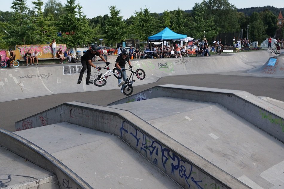 men jump on bicycles