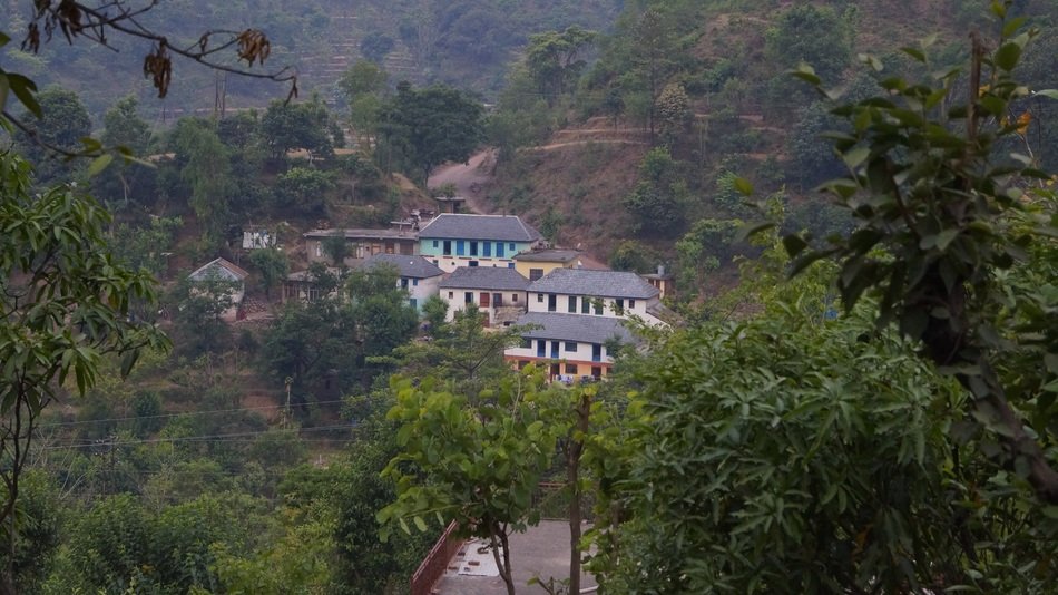 white mansion with a blue roof in manli