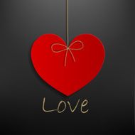 hanging red heart on dark gray background
