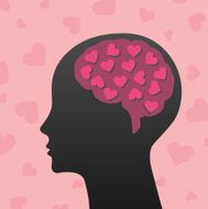 Silhouette of human head with pink hearts