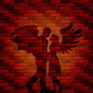 Shadow of angel and demon on brick wall