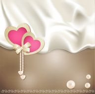 holiday background with beige silk two pink hearts and pearls