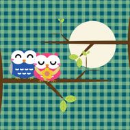 Two cute owls on the tree branch