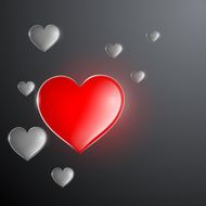 red glowing heart in the midst of gray hearts