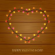 Heart from light on wooden background