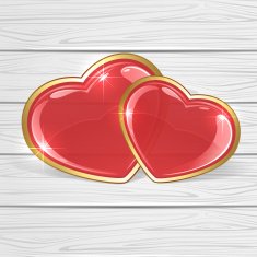Two shiny hearts on wooden background