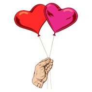 balloons in the form of heart his hand