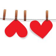 Red paper heart attached to a clothesline with pin