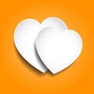 Two paper hearts on orange background
