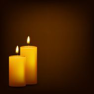 Two burning candles on a dark background