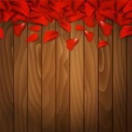 Petals of red rose on wooden background