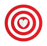 Paper heart in the center of darts target aim