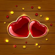 Hearts and beads on wooden background