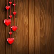 Hanging hearts on wooden background