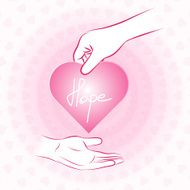 Hand holding pink heart with hope