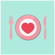 Puzzle heart on disk with fork and spoon
