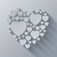 Grey and white paper heart shape on gray background with