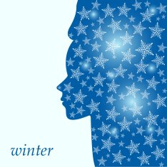 winter background with the silhouette of a woman's face