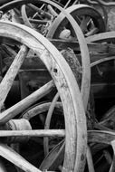 black and white photo of old wooden wheels