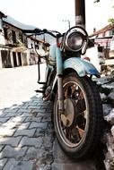 old motorbike on street, front view