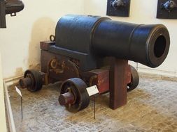 army metal gun near the wall