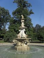 white horse statues in the fountain in the park