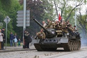 Soldiers with a red flag on a tank at a parade in Prague