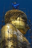 scaffolding on a golden buddha statue