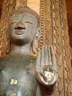 buddha statue with gilded palm, laos