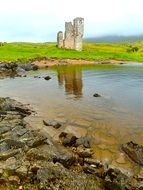 ruins of a building near a lake