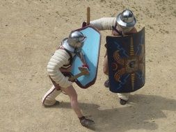 two men fighting, gladiatorial games