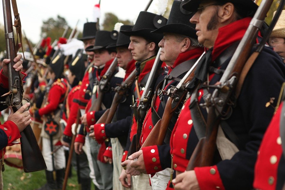 a lot of soldiers with muskets for battle reenactment