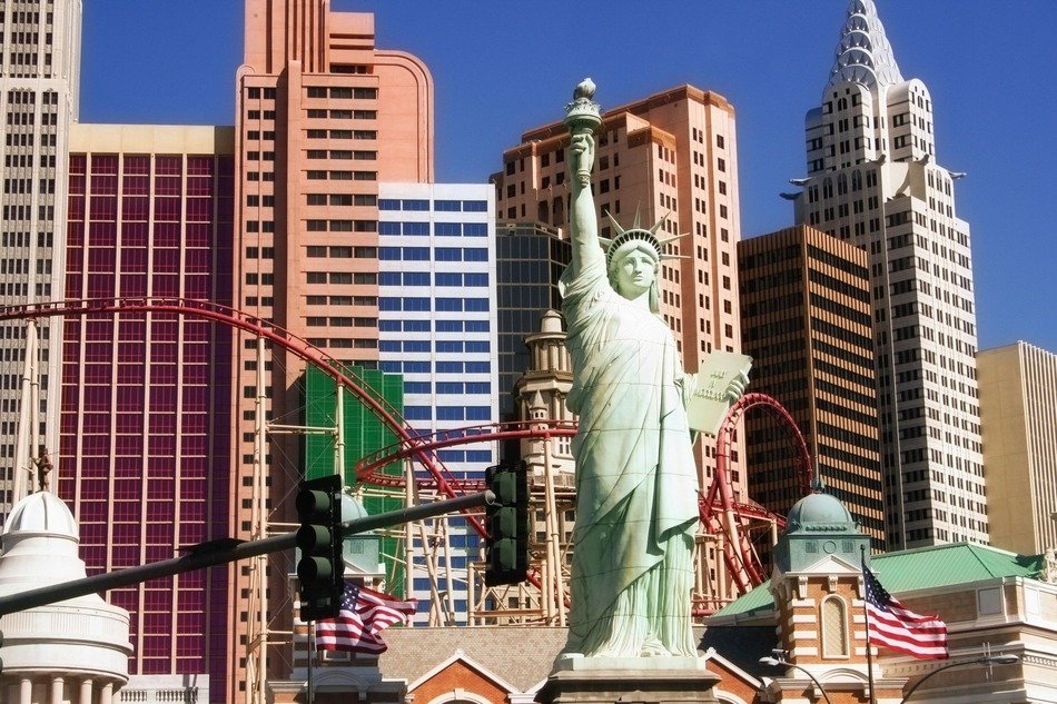 statue of liberty on the background of houses