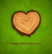 Wooden heart on green background