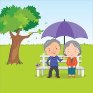 Elderly couple sitting with umbrella