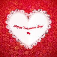Cutout lacy paper heart on red ornate background