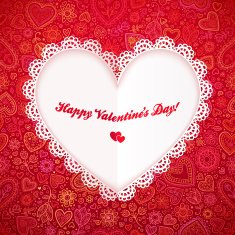 Cutout lacy paper heart on red ornate background