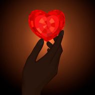 Elegant image of the hand holding red jewel heart