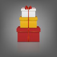 Stack of three realistic gift boxes with red ribbon and